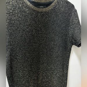 Black and gold shiny tshirt.